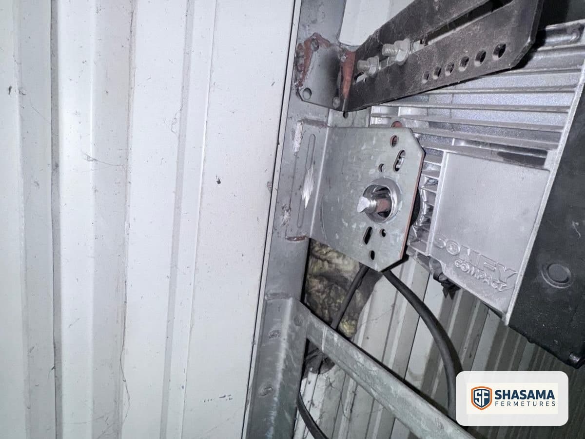 Industrial sectional door shaft bearing and bracket positioned beside the motor at the top
