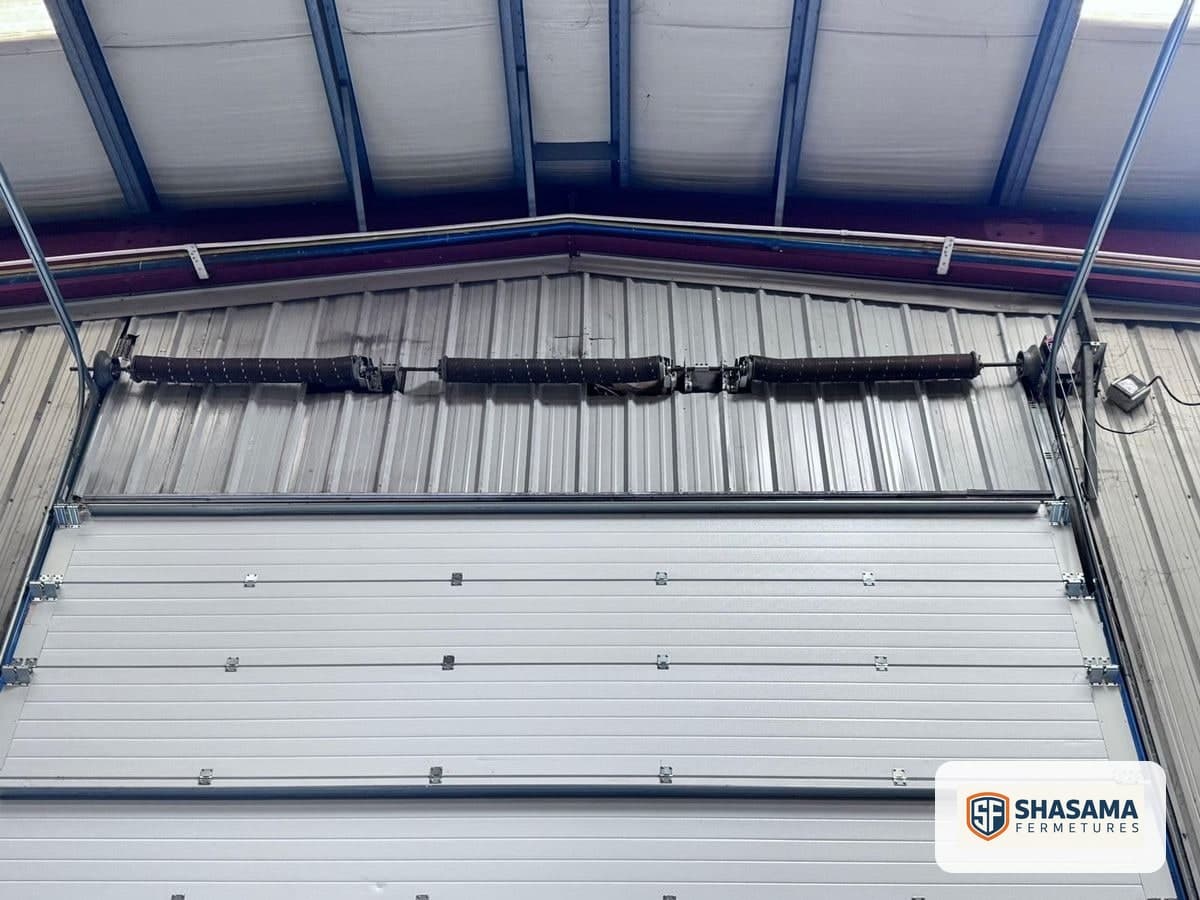 Torsion springs fitted on the industrial sectional door shaft above the closed door panels