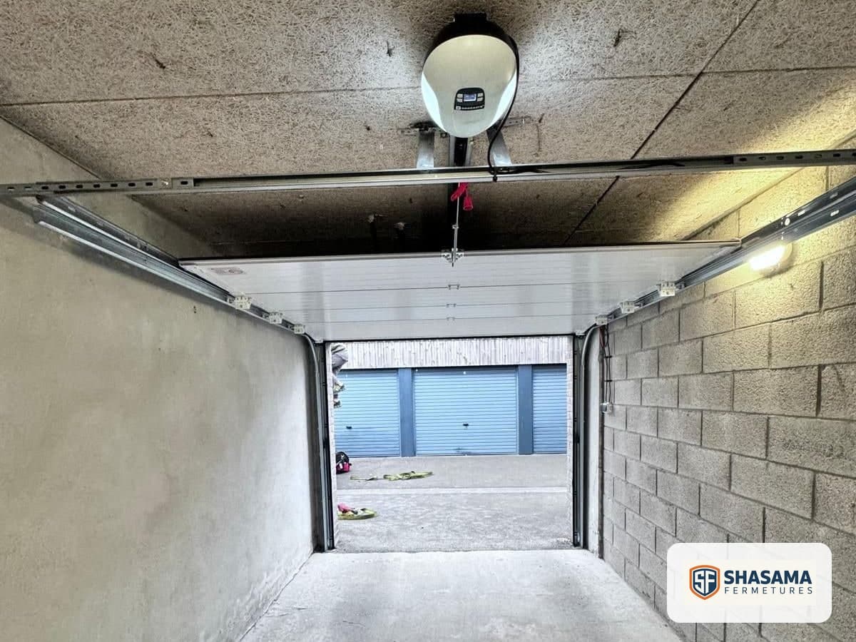 Sectional garage door raised beneath the ceiling, with the motor fitted above the door panels